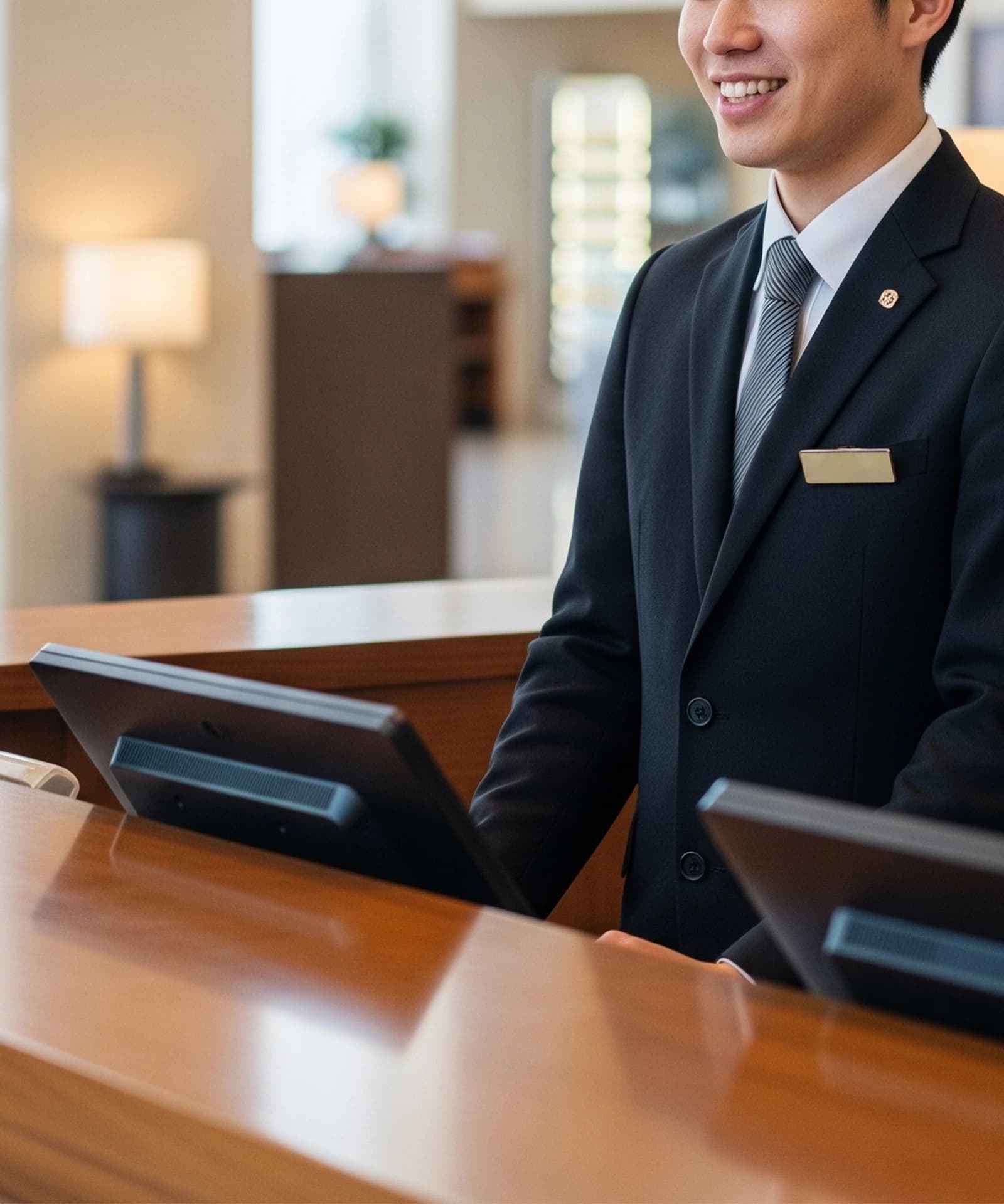 Front desk staff welcoming visitors in a professional office reception area